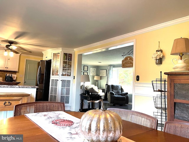 dining area featuring ornamental molding and ceiling fan