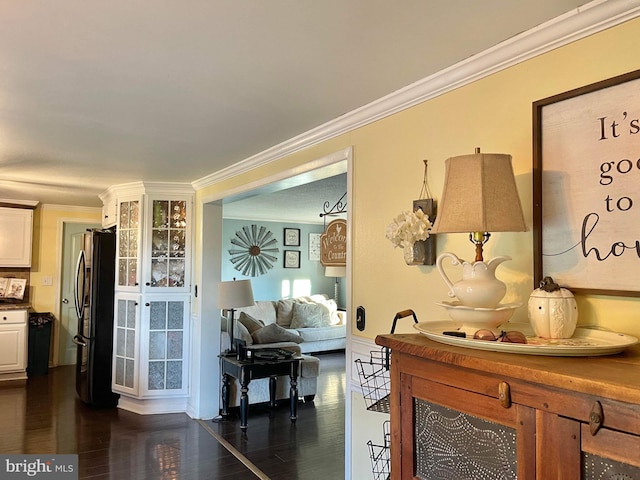 living room featuring ornamental molding and dark hardwood / wood-style flooring