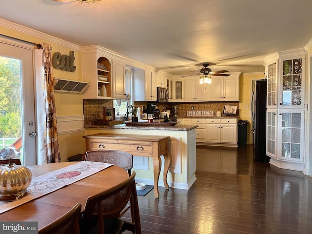 kitchen with white cabinetry, kitchen peninsula, stainless steel appliances, and plenty of natural light