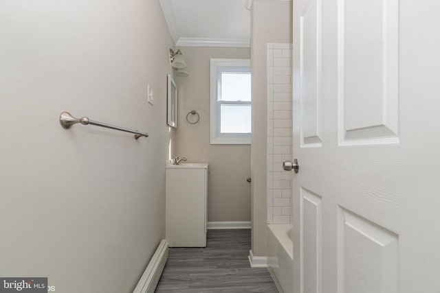 bathroom with hardwood / wood-style flooring and ornamental molding