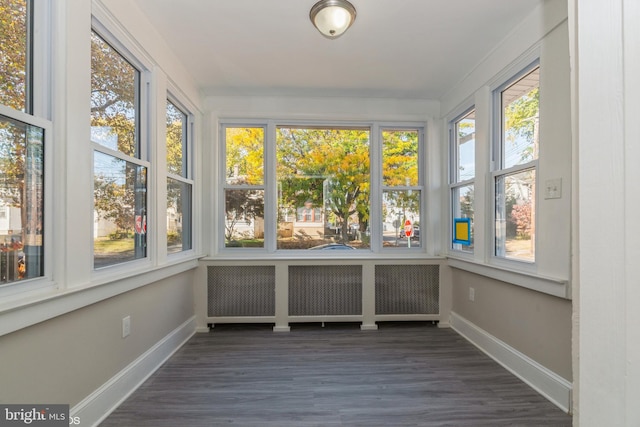 unfurnished sunroom with radiator and plenty of natural light