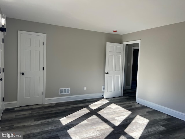 spare room with dark wood-type flooring