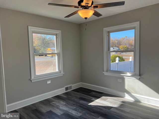 spare room with ceiling fan and dark wood-type flooring