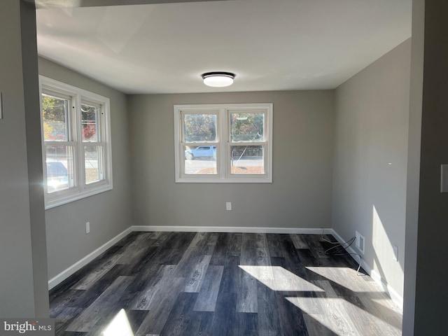 spare room with dark hardwood / wood-style flooring