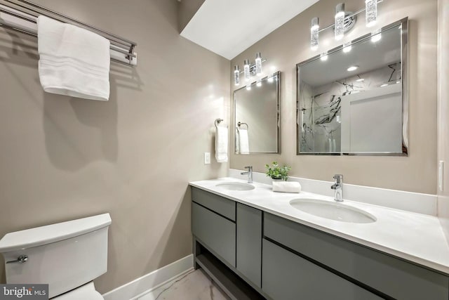 bathroom with vanity, toilet, and a shower