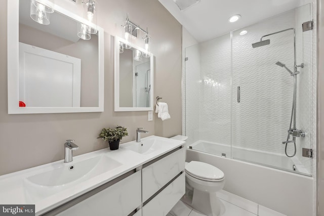 full bathroom featuring combined bath / shower with glass door, tile patterned floors, vanity, and toilet