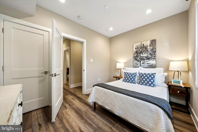 bedroom with dark wood-type flooring