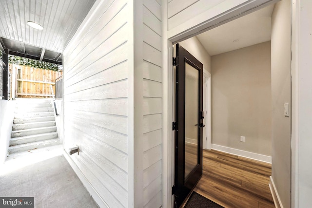 hallway with hardwood / wood-style floors