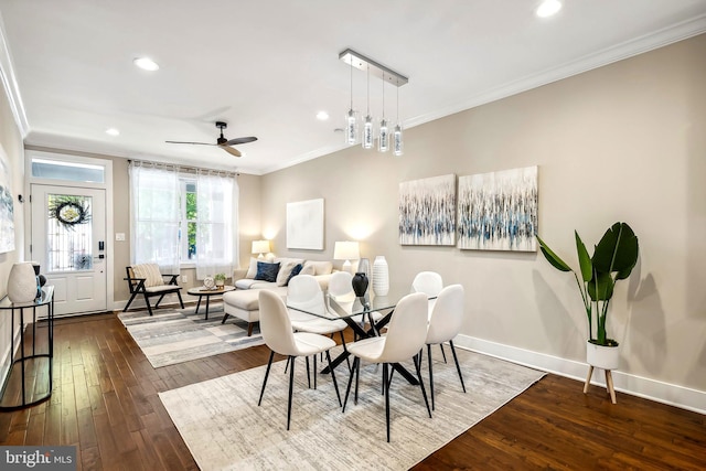 dining area featuring ornamental molding, ceiling fan, and dark hardwood / wood-style floors