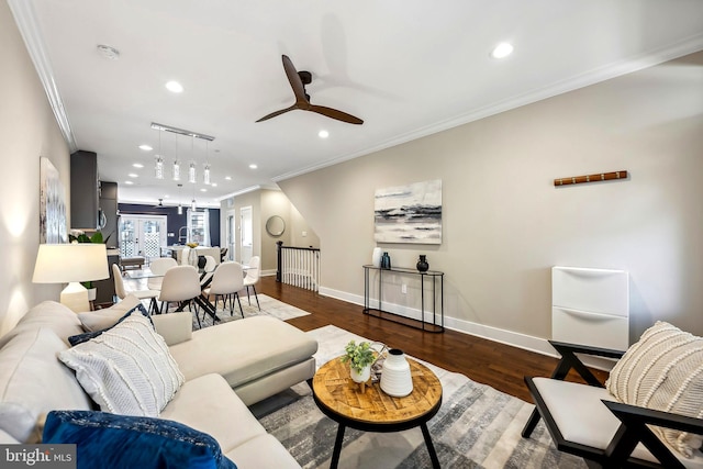 living room featuring crown molding, ceiling fan, and dark wood-type flooring