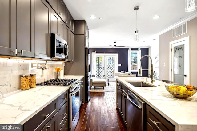 kitchen featuring ornamental molding, sink, pendant lighting, dark hardwood / wood-style flooring, and stainless steel appliances