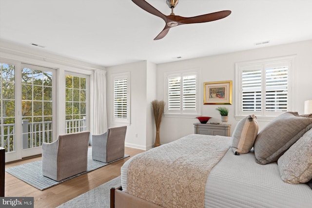 bedroom with access to exterior, multiple windows, and ceiling fan