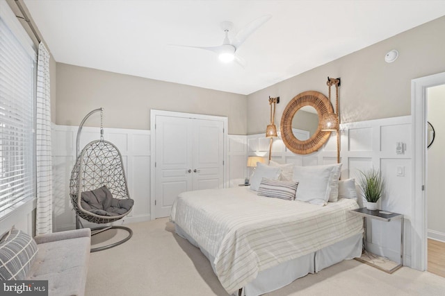 carpeted bedroom with a closet and ceiling fan