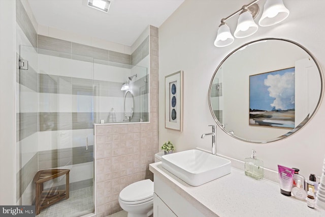 bathroom with vanity, toilet, and a shower with shower door