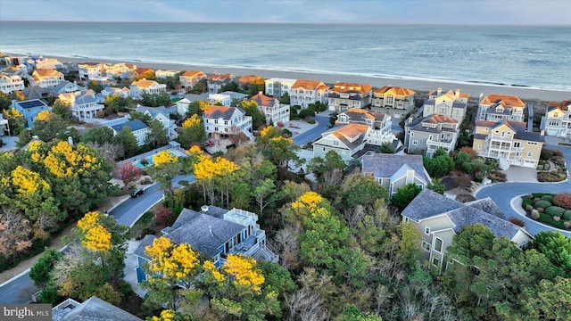 drone / aerial view featuring a water view and a beach view