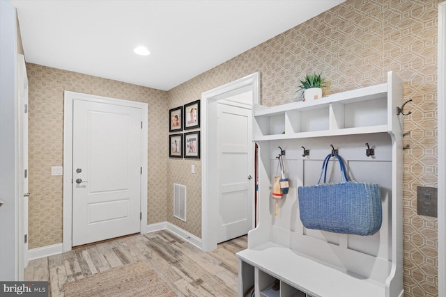 mudroom with light hardwood / wood-style flooring