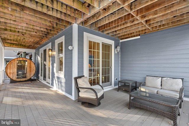 wooden terrace with an outdoor living space