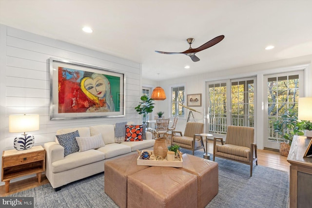 living room with hardwood / wood-style flooring and ceiling fan