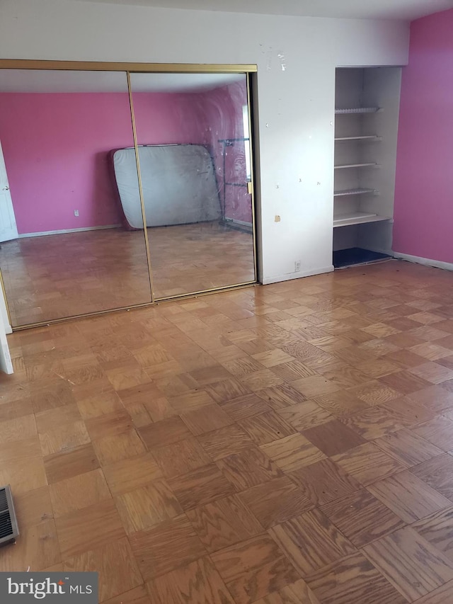 unfurnished bedroom featuring baseboards, a closet, and visible vents
