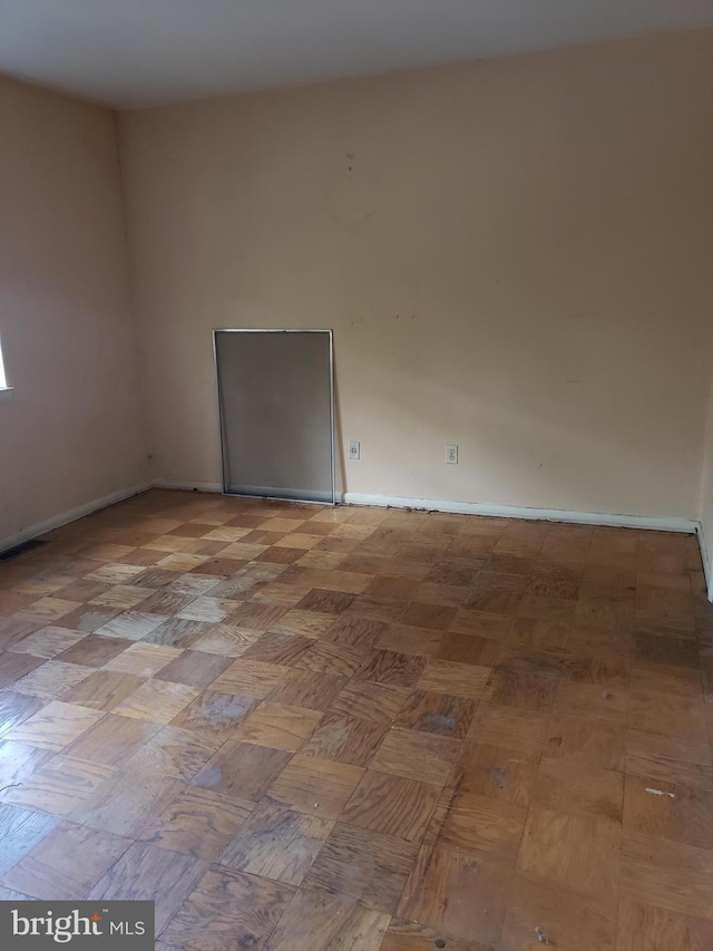 spare room featuring baseboards