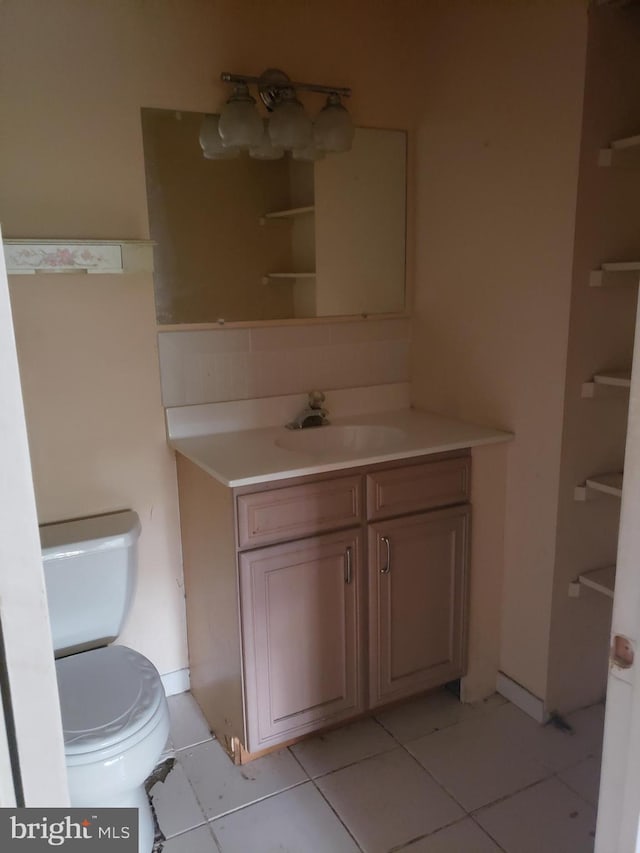 bathroom with vanity, toilet, and tile patterned floors