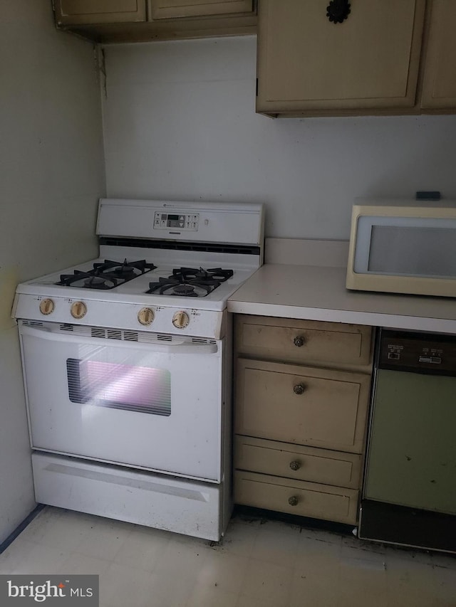 kitchen with light floors, white appliances, and light countertops