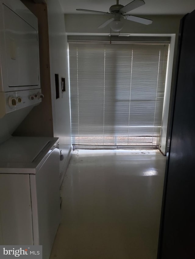 washroom featuring stacked washer / drying machine and ceiling fan