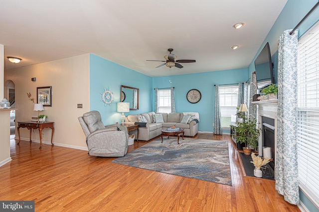 living room featuring light hardwood / wood-style flooring and ceiling fan