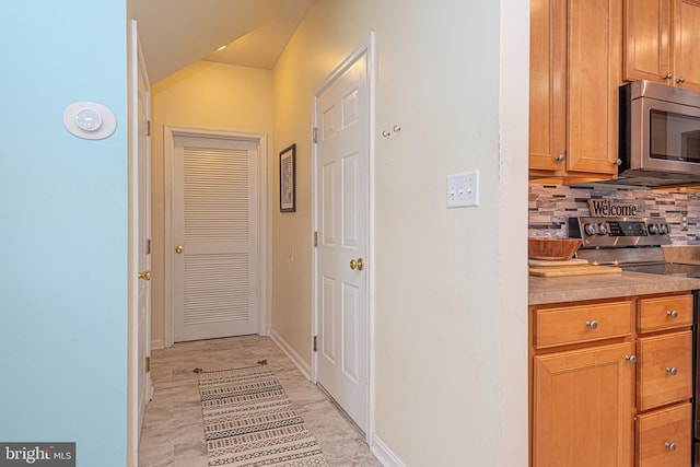 hallway with vaulted ceiling