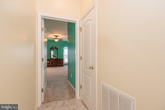 hallway featuring light carpet