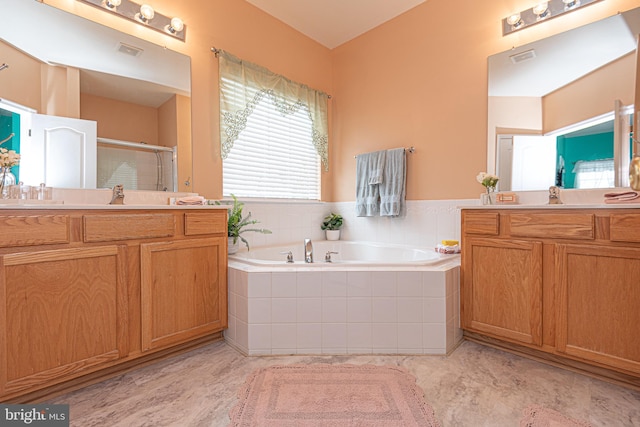 bathroom featuring vanity and shower with separate bathtub