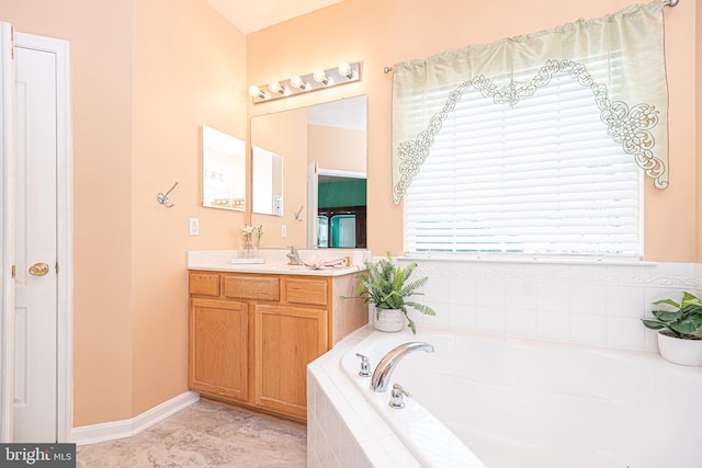 bathroom featuring vanity and tiled tub