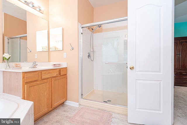 bathroom featuring plus walk in shower and vanity