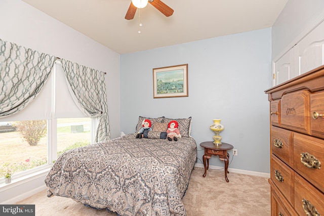 bedroom with ceiling fan and light carpet