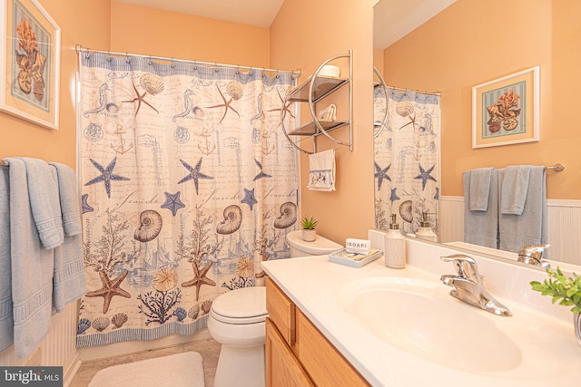 bathroom with tile patterned floors, vanity, a shower with shower curtain, and toilet