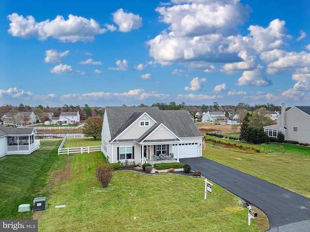 view of front of house with a garage and a front lawn