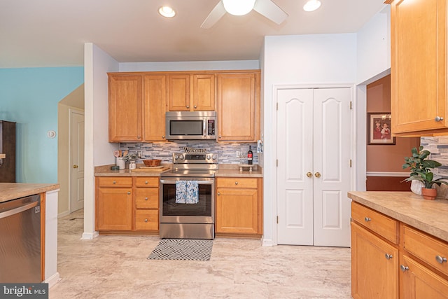 kitchen featuring ceiling fan, decorative backsplash, and stainless steel appliances