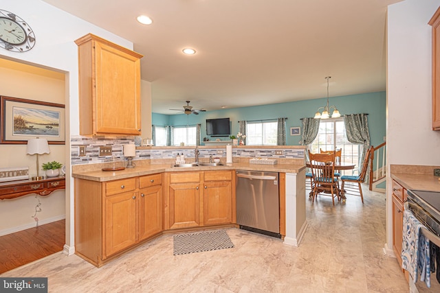 kitchen featuring ceiling fan with notable chandelier, sink, appliances with stainless steel finishes, tasteful backsplash, and kitchen peninsula