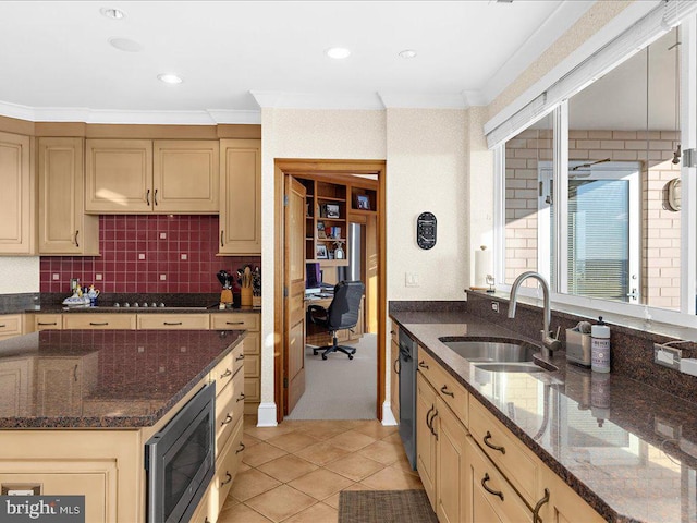 kitchen featuring sink, stainless steel appliances, ornamental molding, decorative backsplash, and dark stone counters