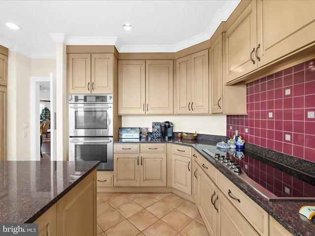 kitchen featuring ornamental molding, stainless steel double oven, black electric cooktop, and dark stone counters