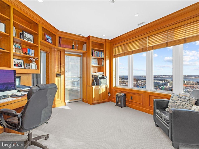 office area with plenty of natural light and light carpet