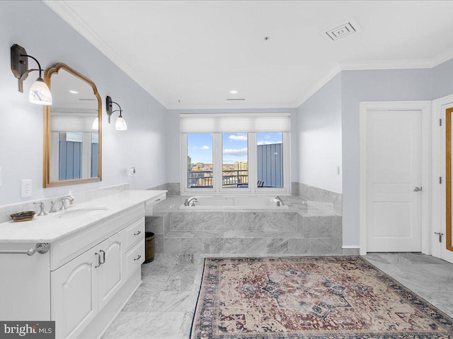 bathroom with ornamental molding, tiled bath, and vanity