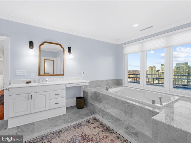 bathroom with tiled tub, ornamental molding, and vanity