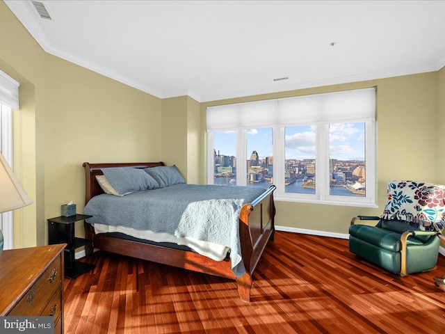 bedroom featuring dark wood-type flooring and crown molding