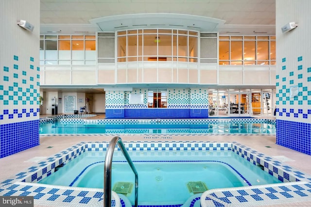 view of pool with an indoor hot tub