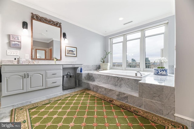 bathroom with crown molding, vanity, and tiled bath