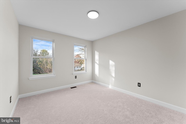 spare room with light carpet