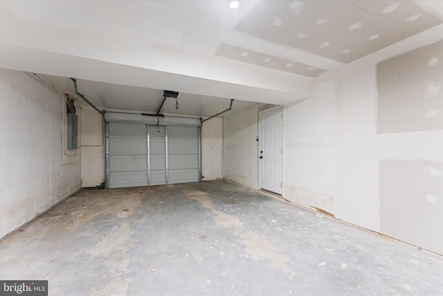 garage with electric panel and a garage door opener