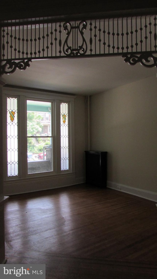 spare room featuring dark wood-type flooring