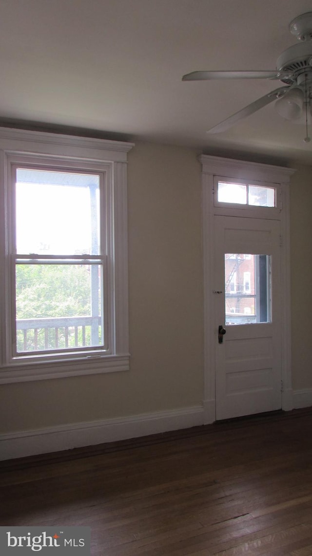 entryway with ceiling fan and dark wood-type flooring